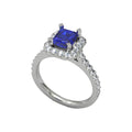 Platinum ring with emerald centre and 32 small round diamonds